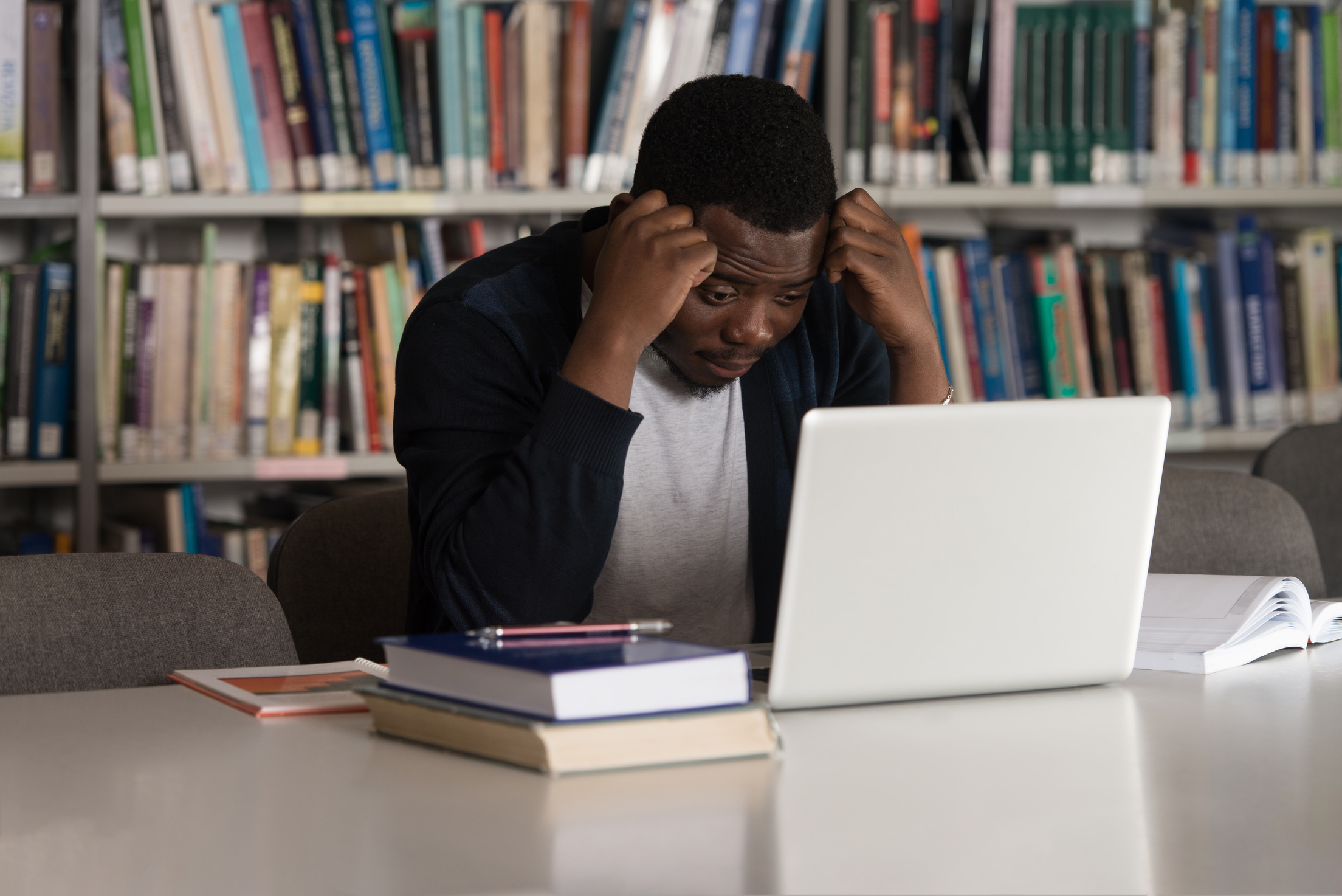 Male College Student Stressed About His Homework